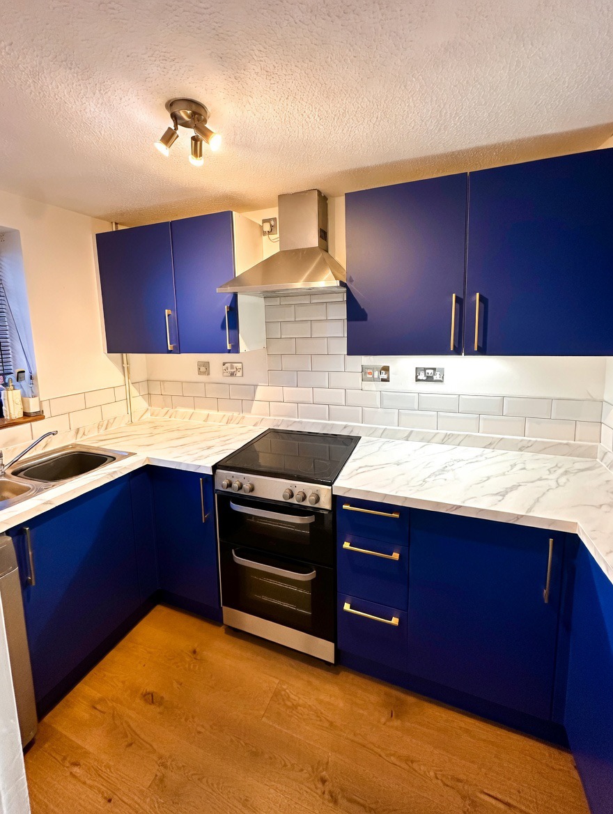 After — royal blue vinyl wrap with marble countertops