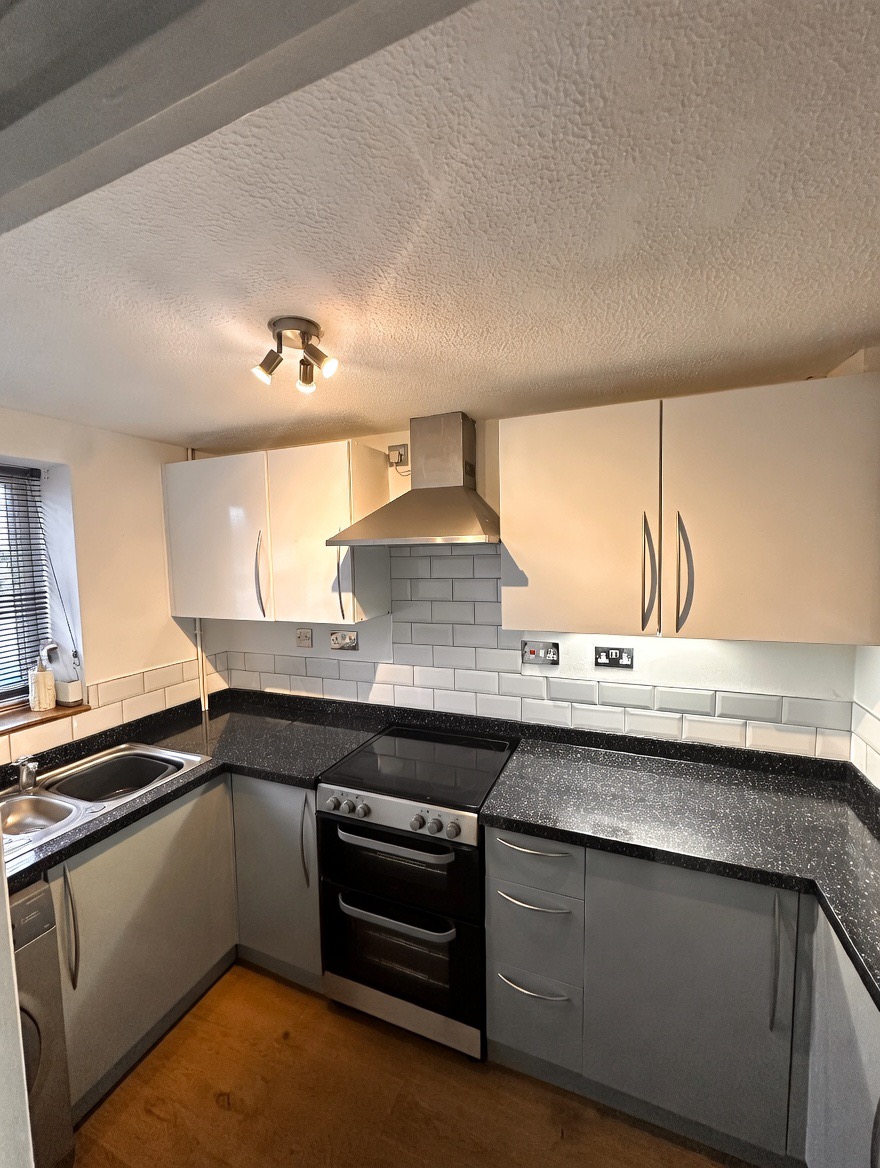 Before — original kitchen with dark countertops